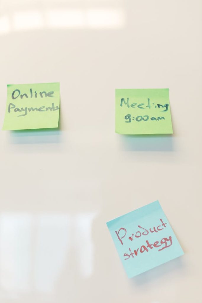 Sticky notes on whiteboard with text on product strategy and meeting schedule. Ideal for business concepts.