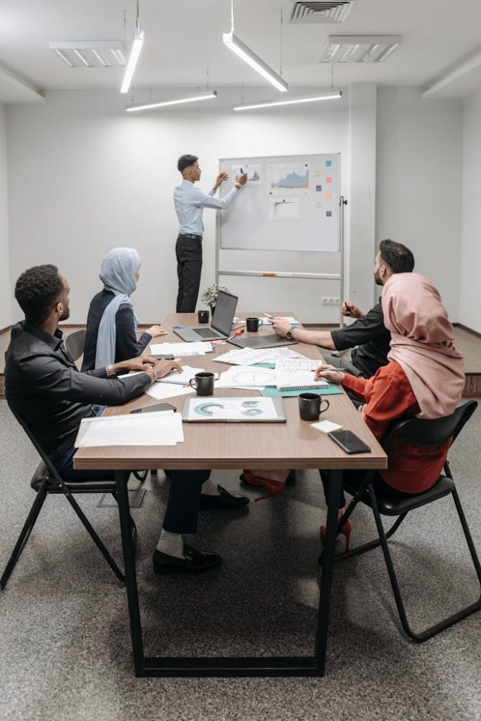 Business meeting with diverse team discussing ideas in modern office.